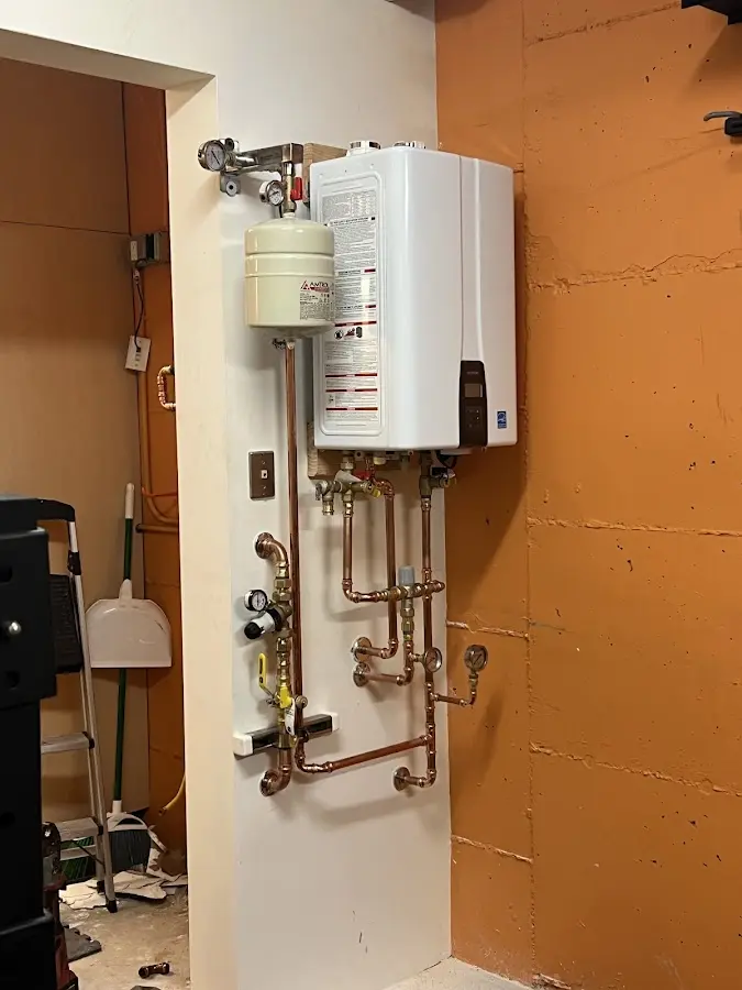 Plumbing technician inspecting water heater connections in Covington